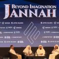Stage panel discussion at 'Beyond Imagination: Jannah' event, four men in white robes seated on stage with a branded backdrop and logos behind them