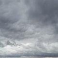 Heavy, dark storm clouds fill the sky, signaling an impending rainstorm (overcast scene).