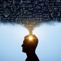 Profile silhouette of a person with sunlight shining from the head, surrounded by chalkboard equations, symbolizing ideas and thinking.