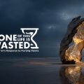 Campaign poster with the slogan 'None of This Life Is Wasted' beside a glowing hourglass-shaped rock and a lone figure on a dark, reflective shoreline at dusk. The subtitle reads 'The Qurans Response to Hurting Hearts'.