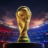 FIFA World Cup trophy on a pedestal in a stadium with a Malaysian flag in the background and bright stadium lights behind it.
